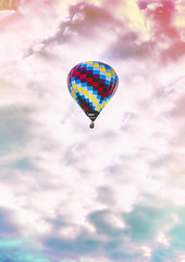 Fototapeta na wymiar Single, colorful hot-air balloon high in the sky