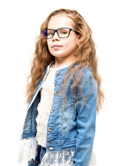 Cute little girl with wavy hair and in casual denim outfit  against white background