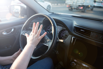  Driving on the sunset. Unrecognizable person drive the car.  Hands holding steering wheel