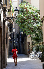 Barcelona, Spain, August 19, 2020: Girl on a red dress wearing protective medical masks to prevent virus Covid-19 in Barcelona, Spain, Europe.