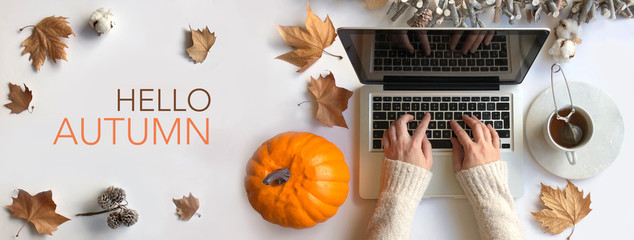 "Hello Autumn" and office desk top with woman typing on laptop