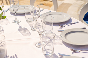 set table with empty dishes and clean glasses