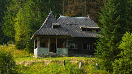 Fototapeta na wymiar Abandoned wooden hut of forest rangers.