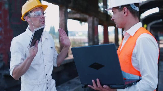 Builder and foreman are discussing, factory building reconstruction for residential lofts. Building a home entails a lot of activities that can be quite confusing to ordinary homeowners. 