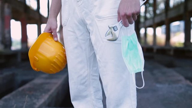 The pandemic is having a catastrophic effect on working hours and earnings globally, causes devastating losses in employment. Policies to mitigate the crisis. Helmet, adjustable wrench and mask.