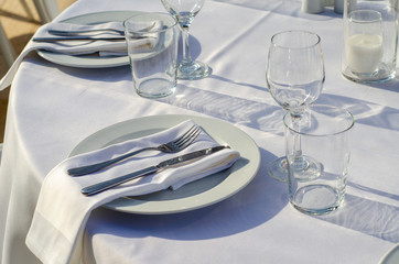 set table with empty dishes and clean glasses