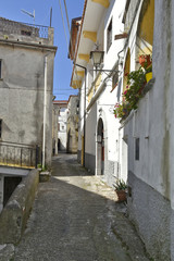 Fototapeta premium A narrow street among the old houses of Aieta, a rural village in the Calabria region.