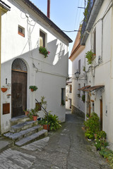 Fototapeta na wymiar A narrow street among the old houses of Aieta, a rural village in the Calabria region.