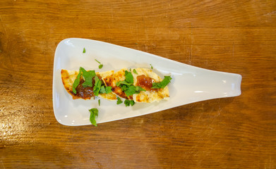 waiter hold on hand plate with fried cheese with sauce