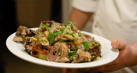 waiter hold on hand plate with meat