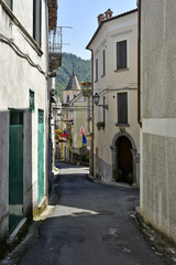Fototapeta na wymiar A narrow street among the old houses of Laino Borgo, a rural village in the Calabria region.