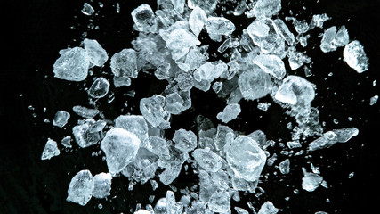 Crushed ice in motion, isolated on black background.