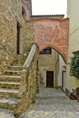 Naklejka premium A narrow street among the old houses of Scalea, a rural village in the Calabria region, Italy.