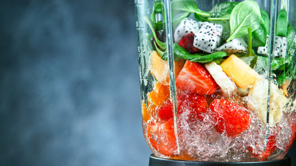Fresh fruit and vegetables smoothie blended in blender, back view. Healthy eating concept.