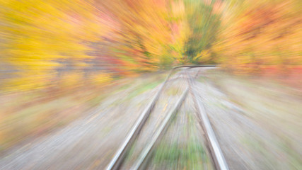 Dreamy image of railway lines among the beautiful autumn colors in Quebec, Canada. Image taken by intentional camera movement. 