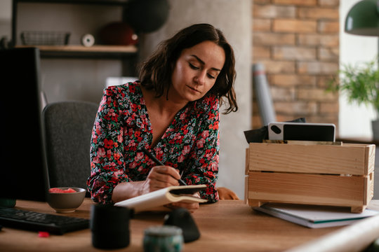 Businesswoman taking note. Businesswoman writing business plan..
