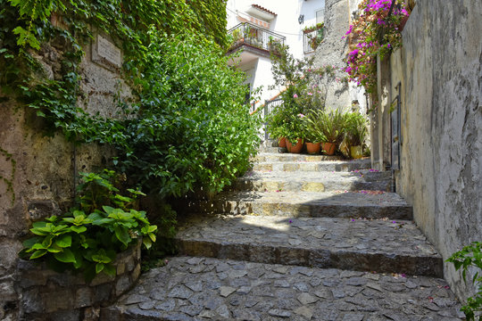 A narrow street among the old houses of Scalea, a rural village in the Calabria region, Italy.