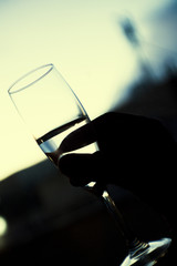 Silhouette of glass with champagne held by a hand