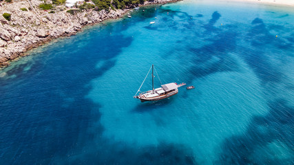 Aerial drone top down photo of pirates boat yacht with wooden deck anchored in open ocean sea