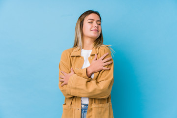 Young caucasian woman hugs, smiling carefree and happy.