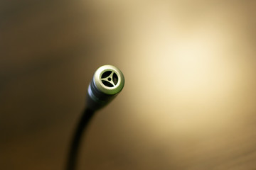 Small portable microphone close-up and blurry background.