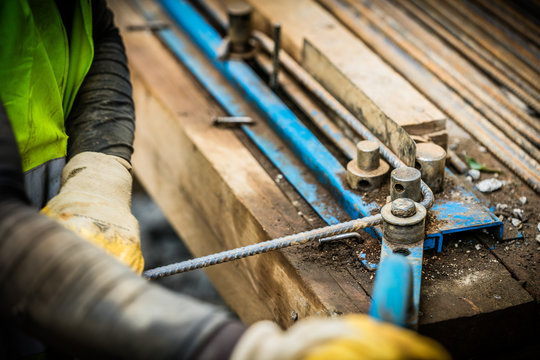 Worker with steeel for concrete on construction site