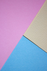 Colorful blue, pink and yellow paper backgrounds.