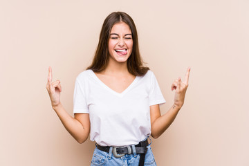 Young funny woman isolated on beige background