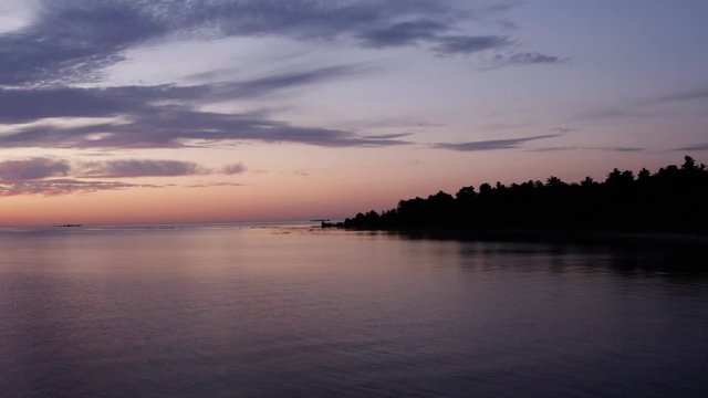 Pulling Away From Coast at Sunrise over Great Lake Aerial. Depart land, rising