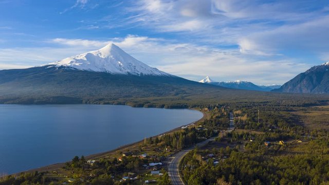 aerial hyperlapse towards the osorno volcano with its top covered with snow, on a sunny winter day