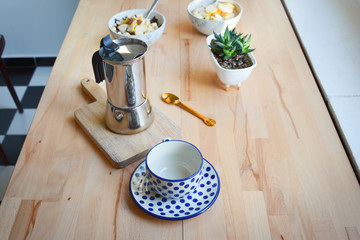 Coffee preparing in moka pot. Italian moka kettle. Brewing coffee at home. Woman hands. Woman preparing coffee in traditional Italian moka pot. Wooden table.