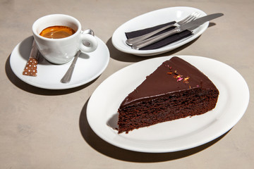 Dark chocolate cake in a dish with coffee