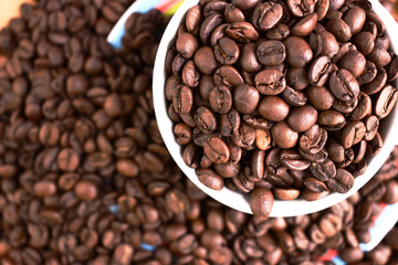 Cup full of coffee beans. Close up. Copy space. Abstract background texture. Coffee beans texture.