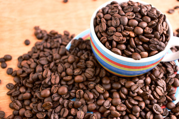 Cup full of coffee beans. Close up. Copy space. Abstract background texture. Coffee beans texture.