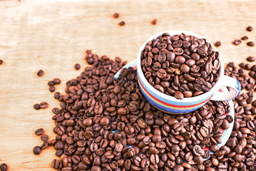 Cup full of coffee beans. Close up. Copy space. Abstract background texture. Coffee beans texture.