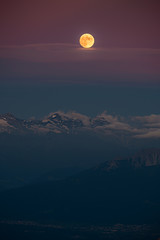 The full moon over the alpine moutains. Picture was taken on the summit Zugspitze, highest mountain in Germany. 