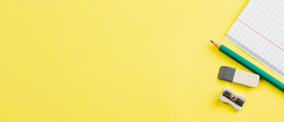 Blank notebook with a pencil on a yellow background. Photo banner. Place for your text. View from above. Education concept.