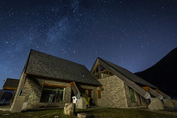Mountain Chalet with milkyway background