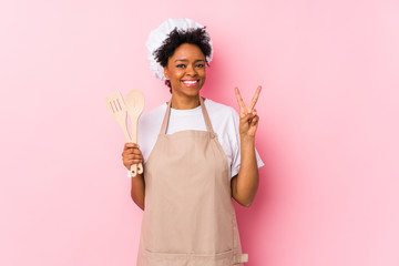 Young african american cook woman showing number two with fingers.