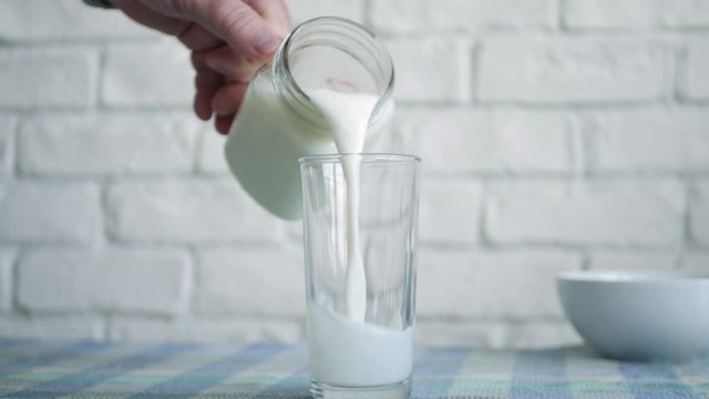 One Person Fill a Glass with Fresh Milk for Breakfast a Healthy, Tasty and Natural Drink Full with Protein and Vitamins