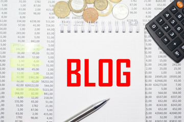 Blog on the block on the background of financial reporting, coins, calculator, pens and yellow stickers. Business concept