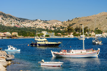 Fototapeta na wymiar Picturesque Bay with fishing boats in the village of Pedi, Symi island, Dodecanese Islands, Greece