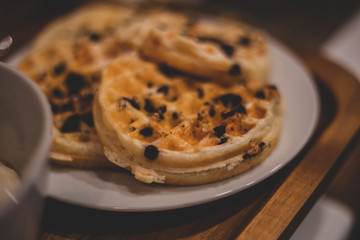 chocolate chip waffles stacked on plate
