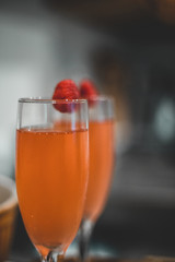Sparkling drink in wine glass with raspberry 