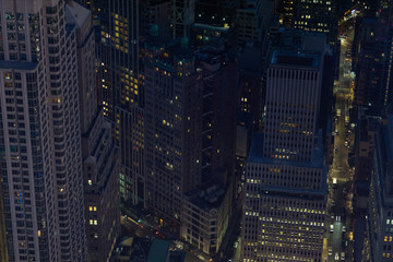 Looking down from a skyscraper to Manhattan buildings and streets in financial district of Manhattan in New York City at night