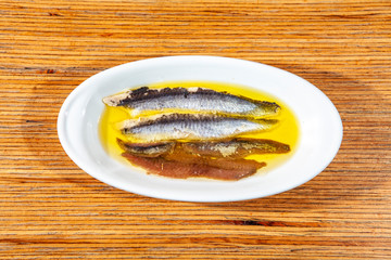 Anchovy tapa dish in a wooden background 