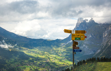 A trail sign on the Eiger trail in the Alps mountains above Lauterbrunnen, Switzerland.  The...