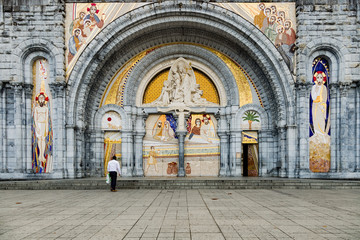 Front entrance of the Basilica of the Rosary in Lourdes with pilgrims