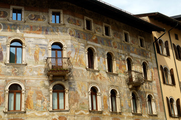Fototapeta na wymiar Trento, Italy: painted facade of historic buildings in the cathedral square