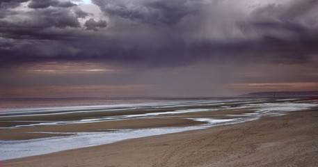 Rain and sunset on the Normandy seashore